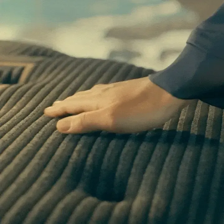 gif of hand feeling texture of mattress