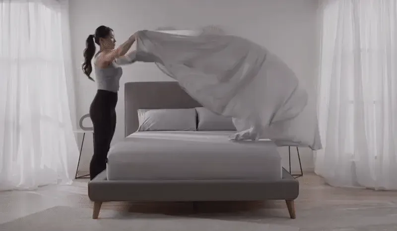 video clip of sheets being draped across a mattress to show airflow.