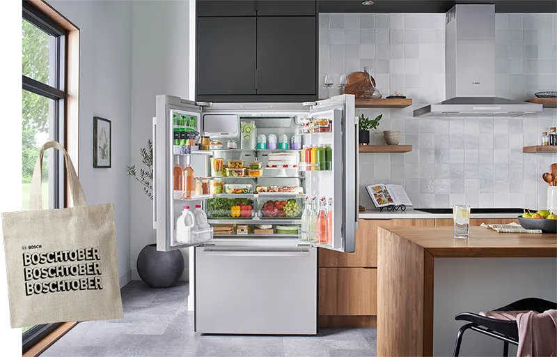 Open Bosch French door refrigerator full of fresh food