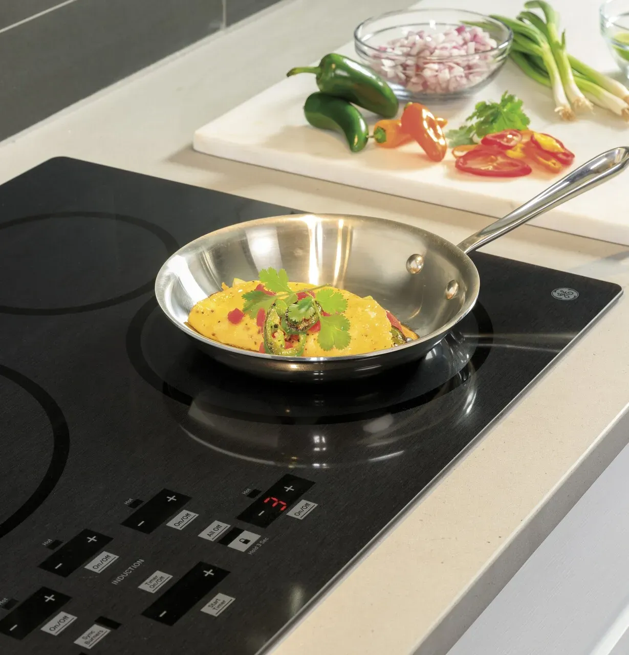 Someone cooking in a pan on an induction cooktop