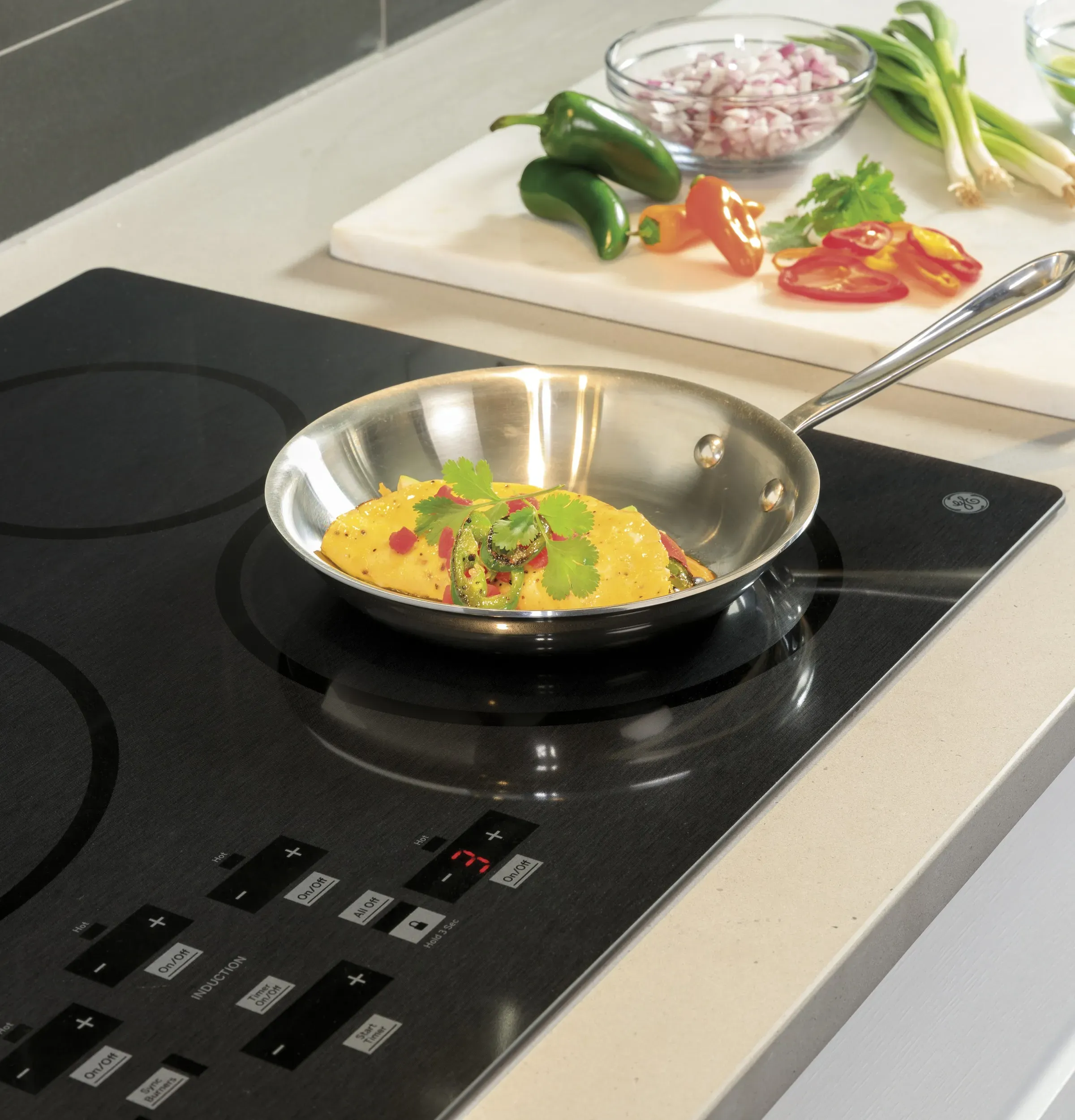 Someone cooking in a pan on an induction cooktop