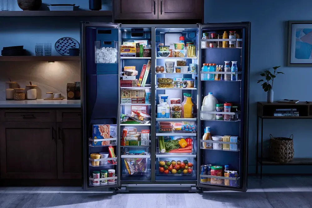kitchen image focused on refrigerator with both french doors open showing interior storage and features
