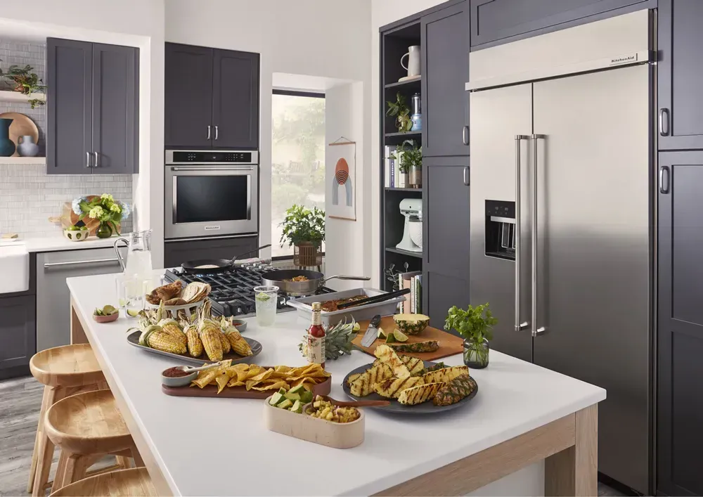 slide 2 lifestyle kitchen image with refrigerator, wall oven and dishwasher