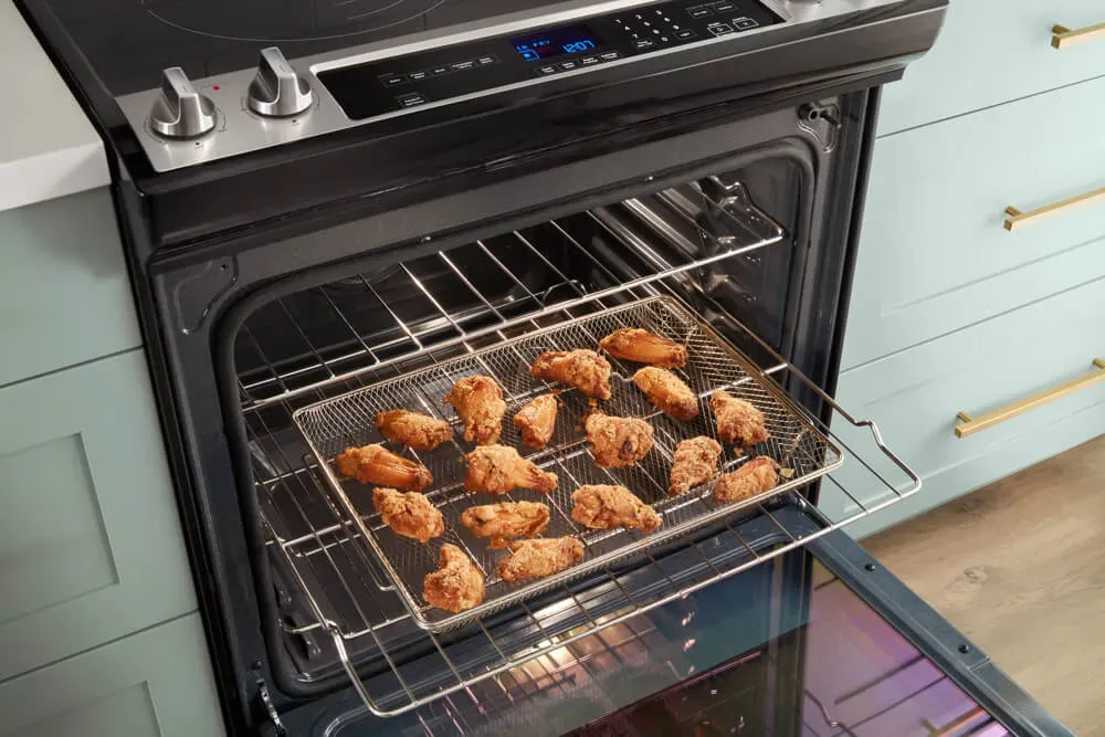 crispy chicken wings in open oven, showcasing air fry mode