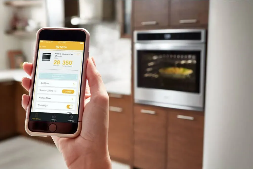 hand holding smartphone to show smart controls for whirlpool appliances