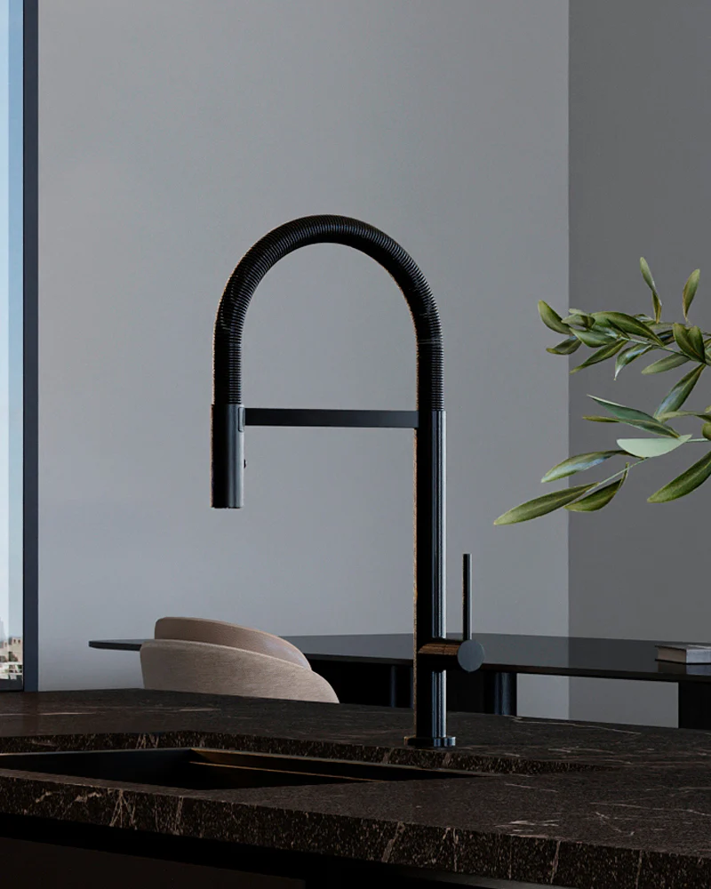 Modern black kitchen faucet on a marble countertop with a neutral background.
