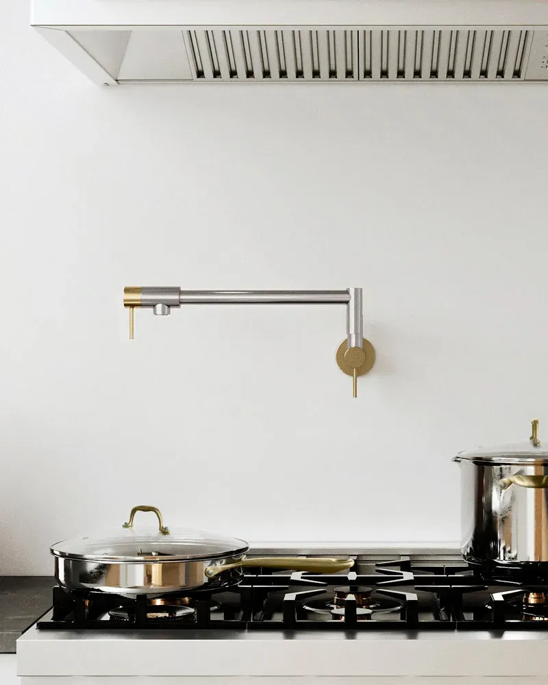 Modern kitchen with a two-tone stainless steel pot filler and cooktop.