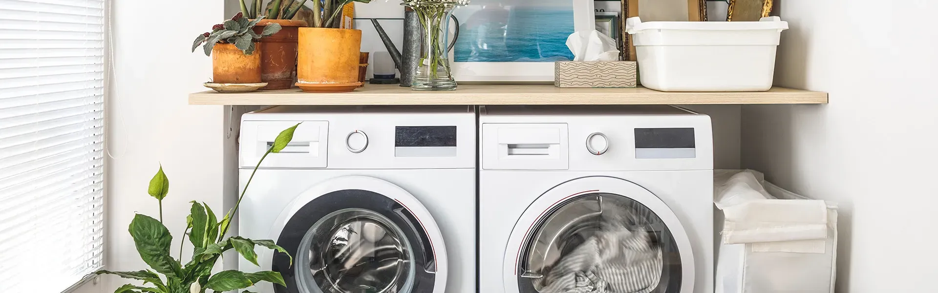 Modern laundry room with white front-load washer and dryer set