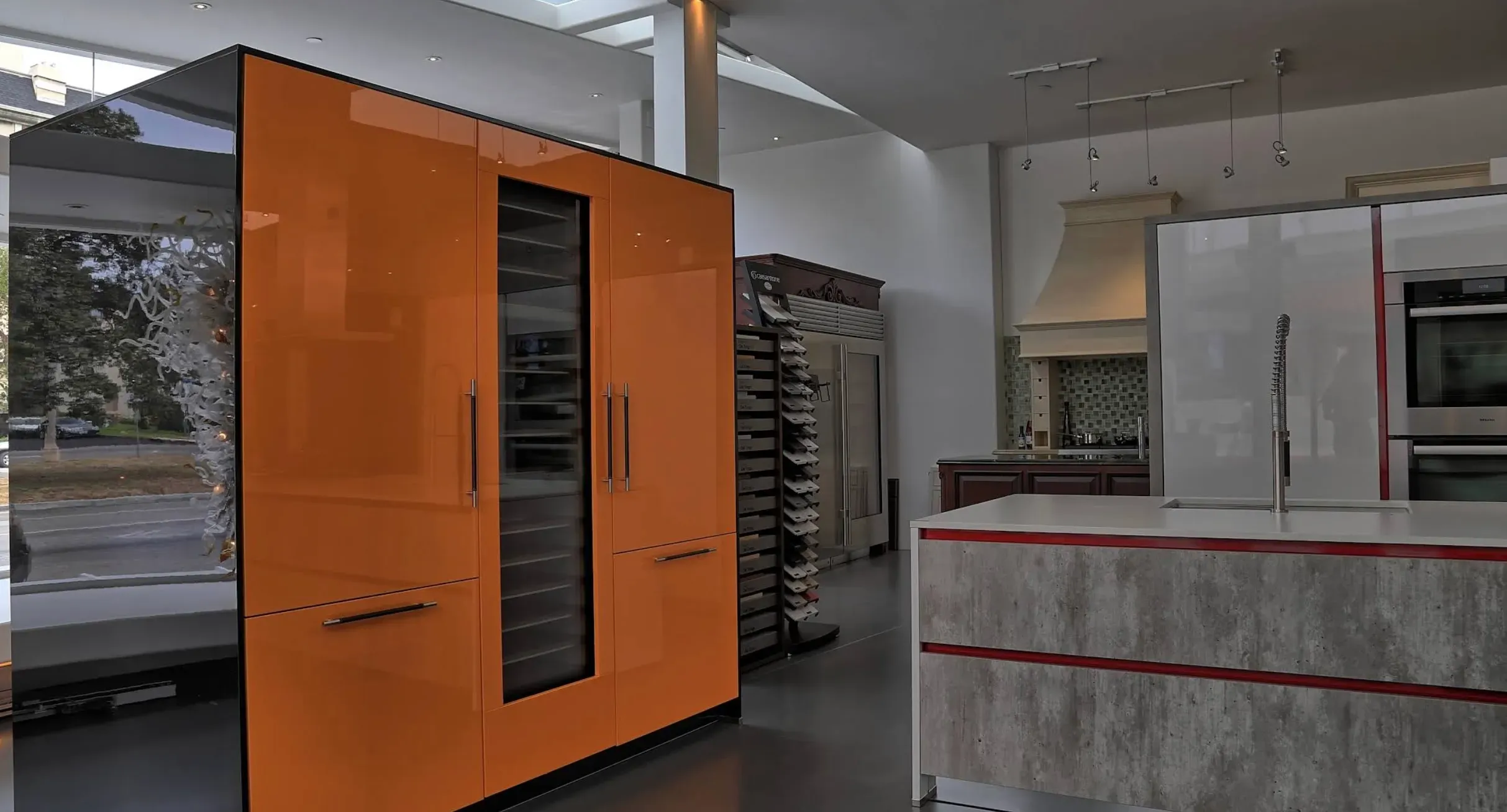 High-gloss orange cabinets and waterfall island