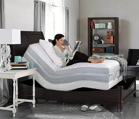 Adjustable bed base with a person reclining, representing the Adjustables category