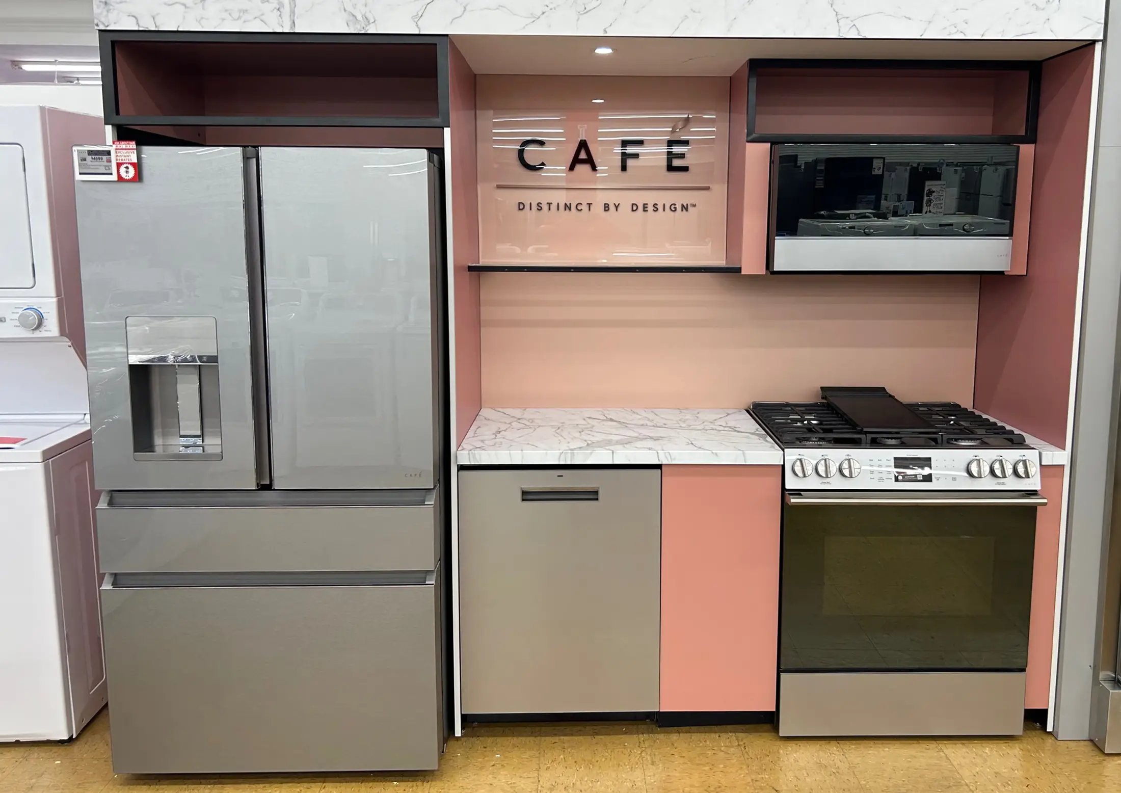 Modern kitchen appliances display with refrigerator, oven, and microwave.