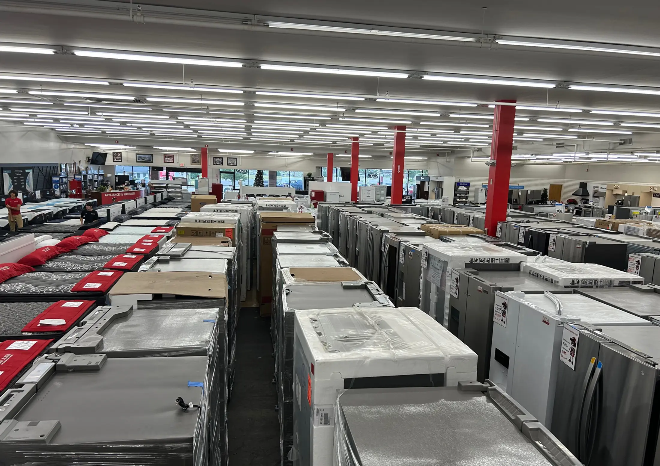 Modern kitchen appliances display with refrigerator, oven, and microwave.
