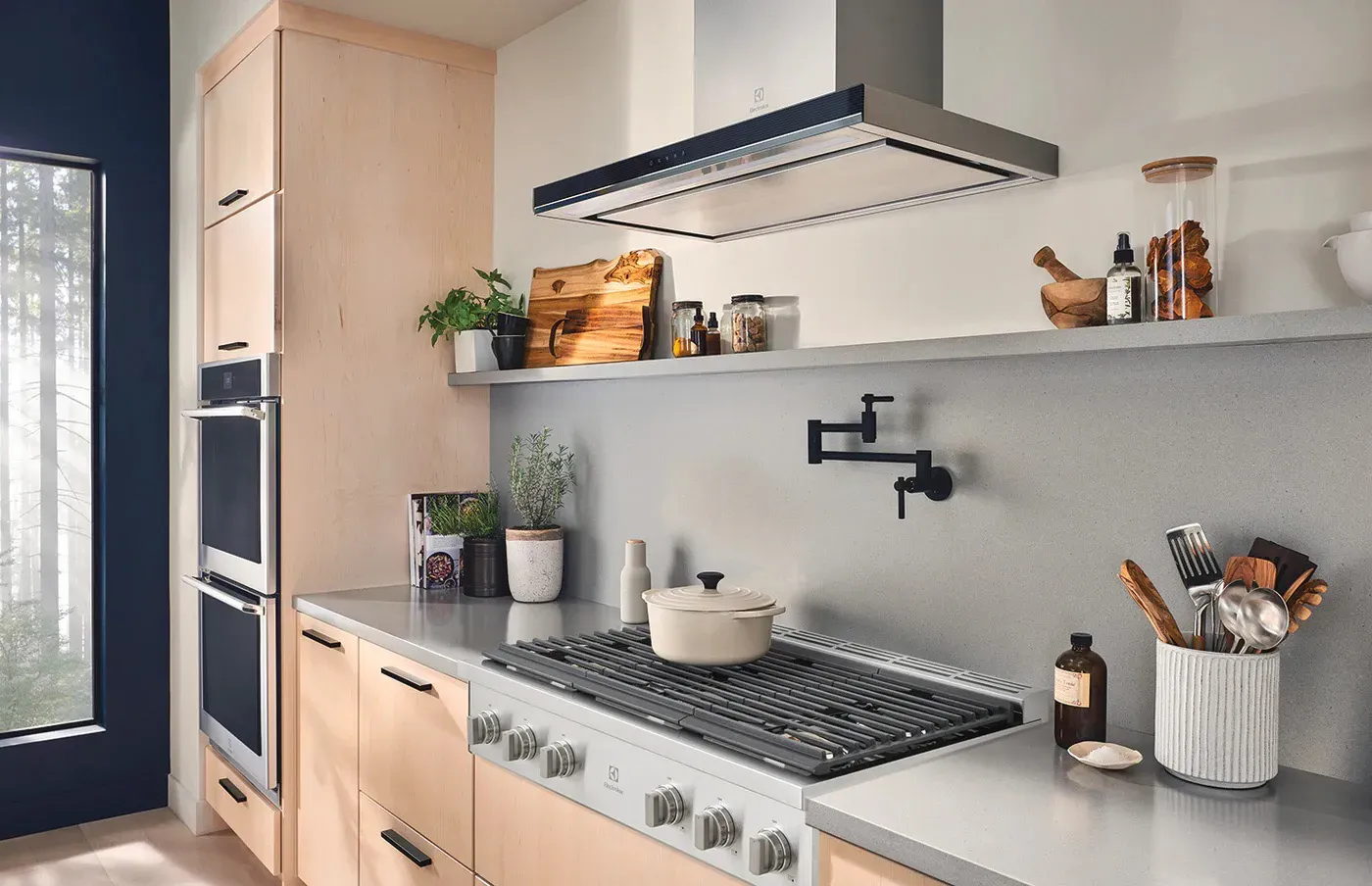 Contemporary kitchen with range and hood