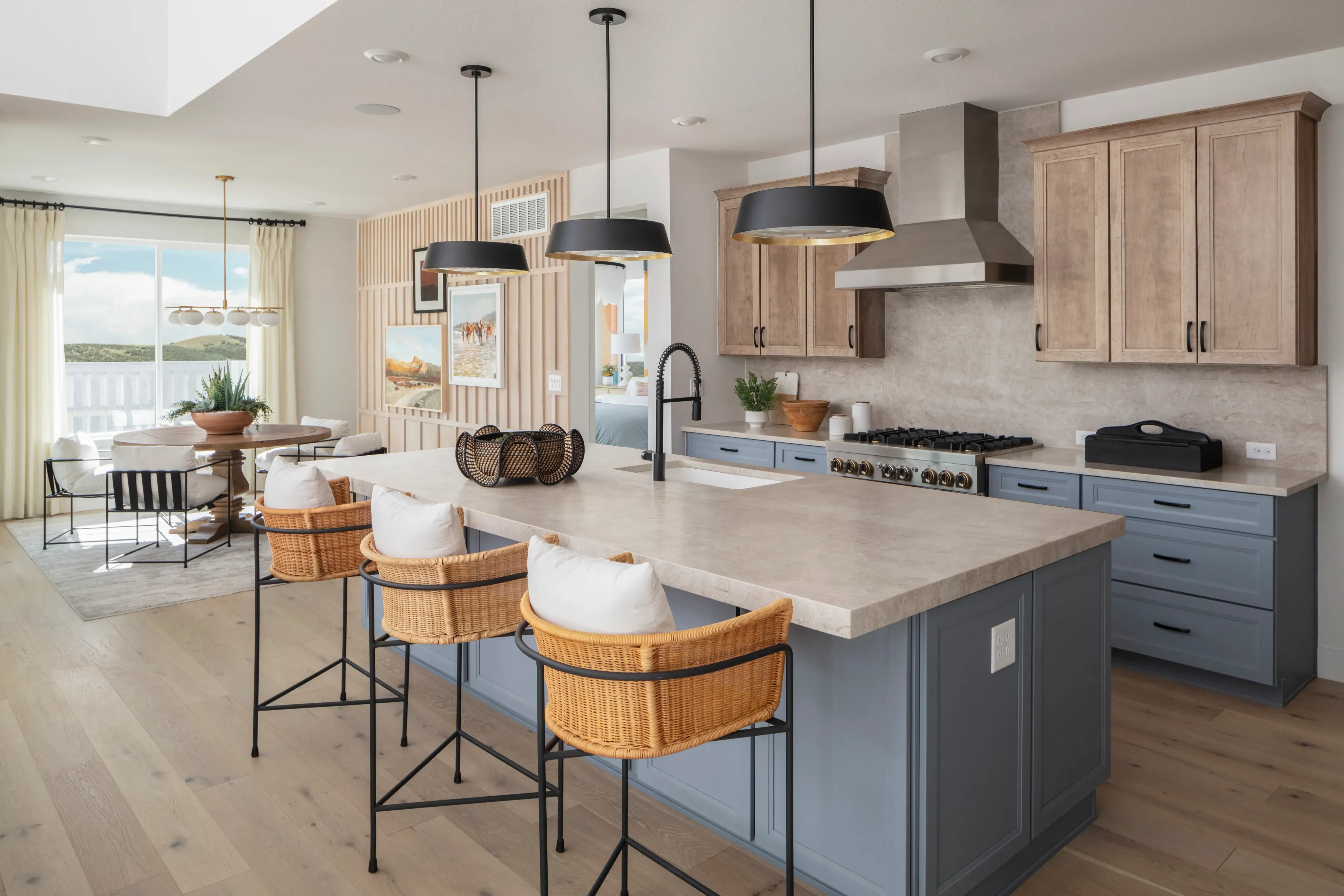 Modern kitchen interior design with marble countertops, wood flooring, and tiled backsplash