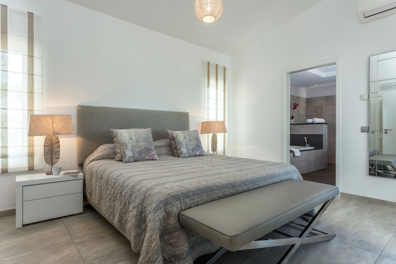 Modern bedroom with a bed, side lamp and window