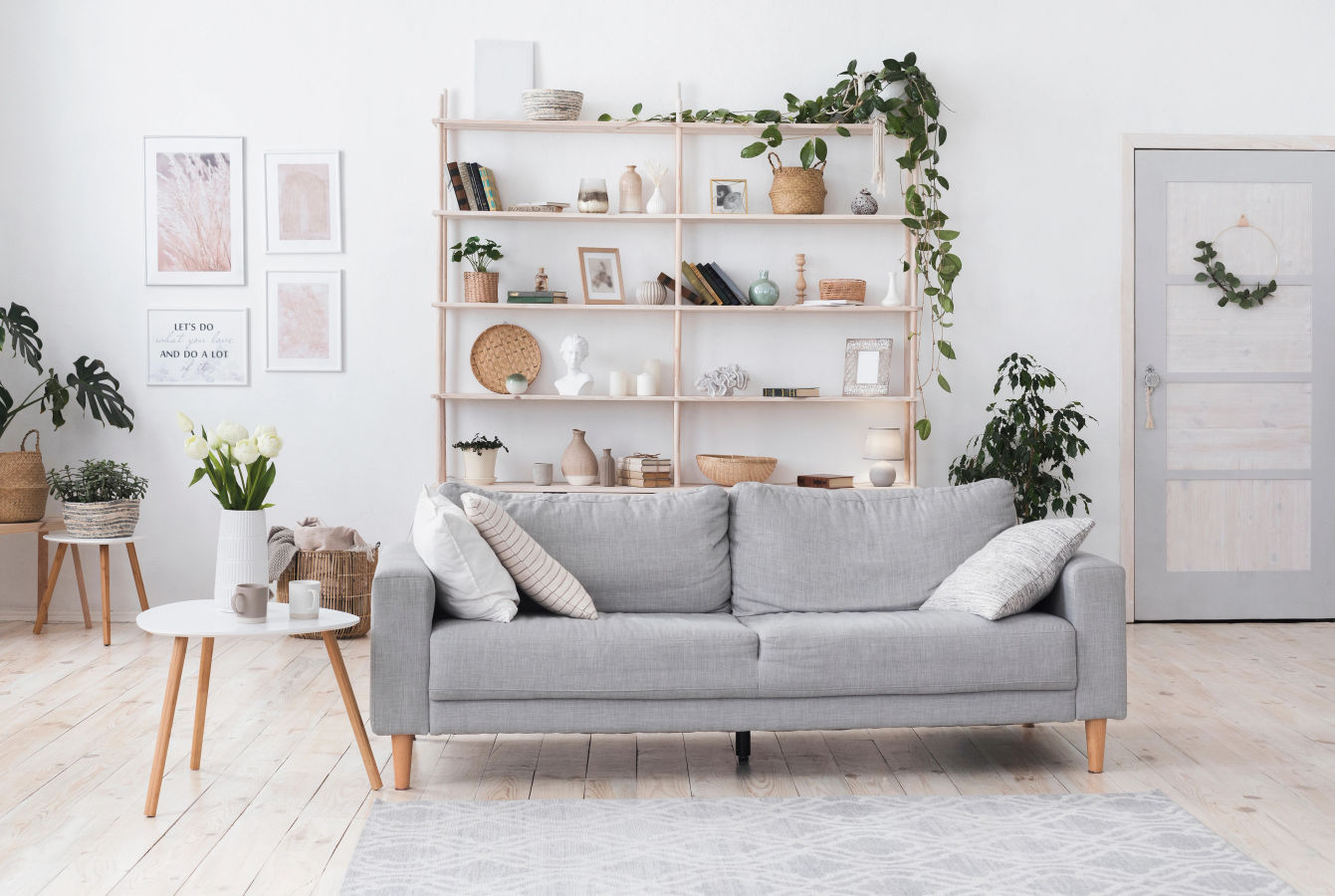 Stylish living room with a light couch, house plants and a large window