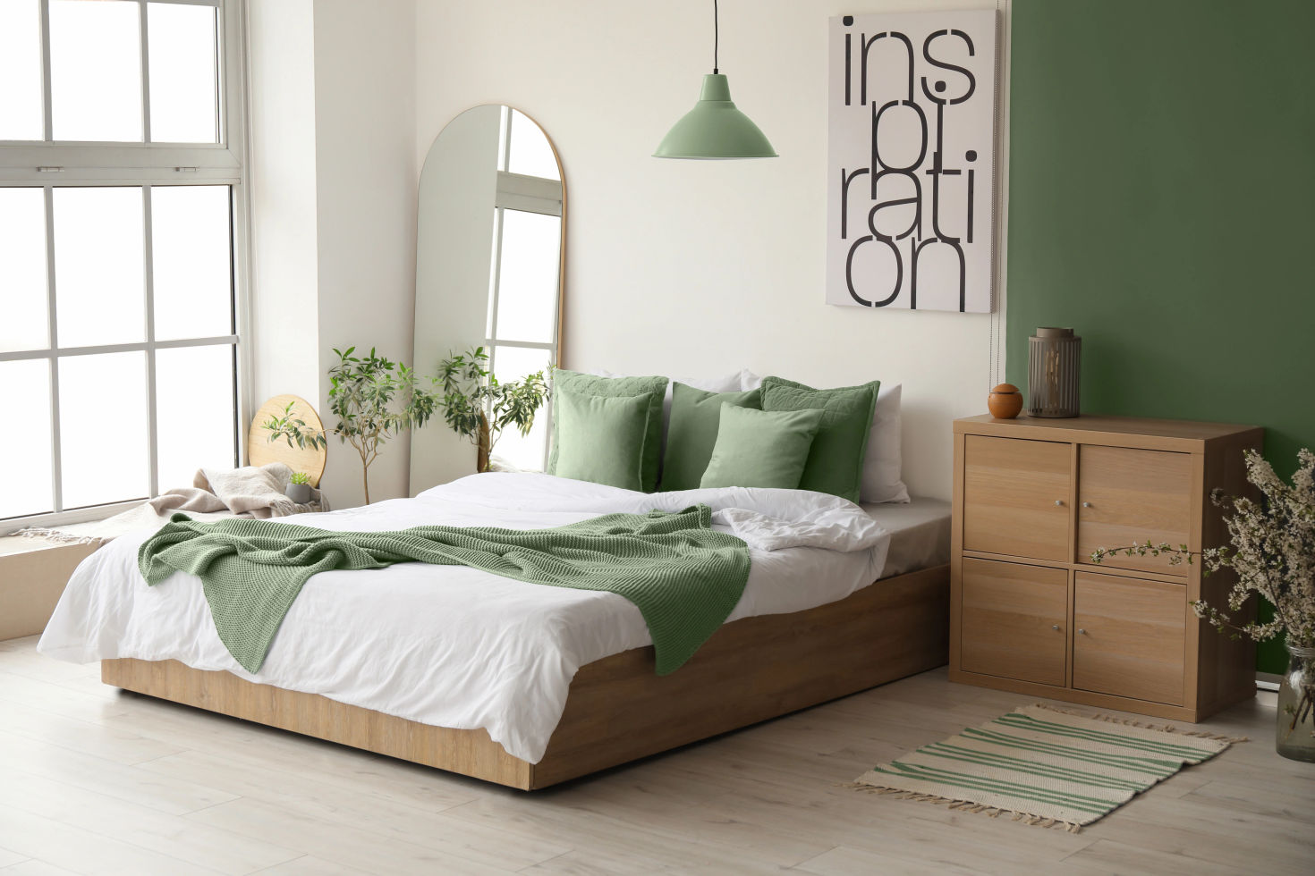 Contemporary bedroom with a large bed, folded blanket and cabinet