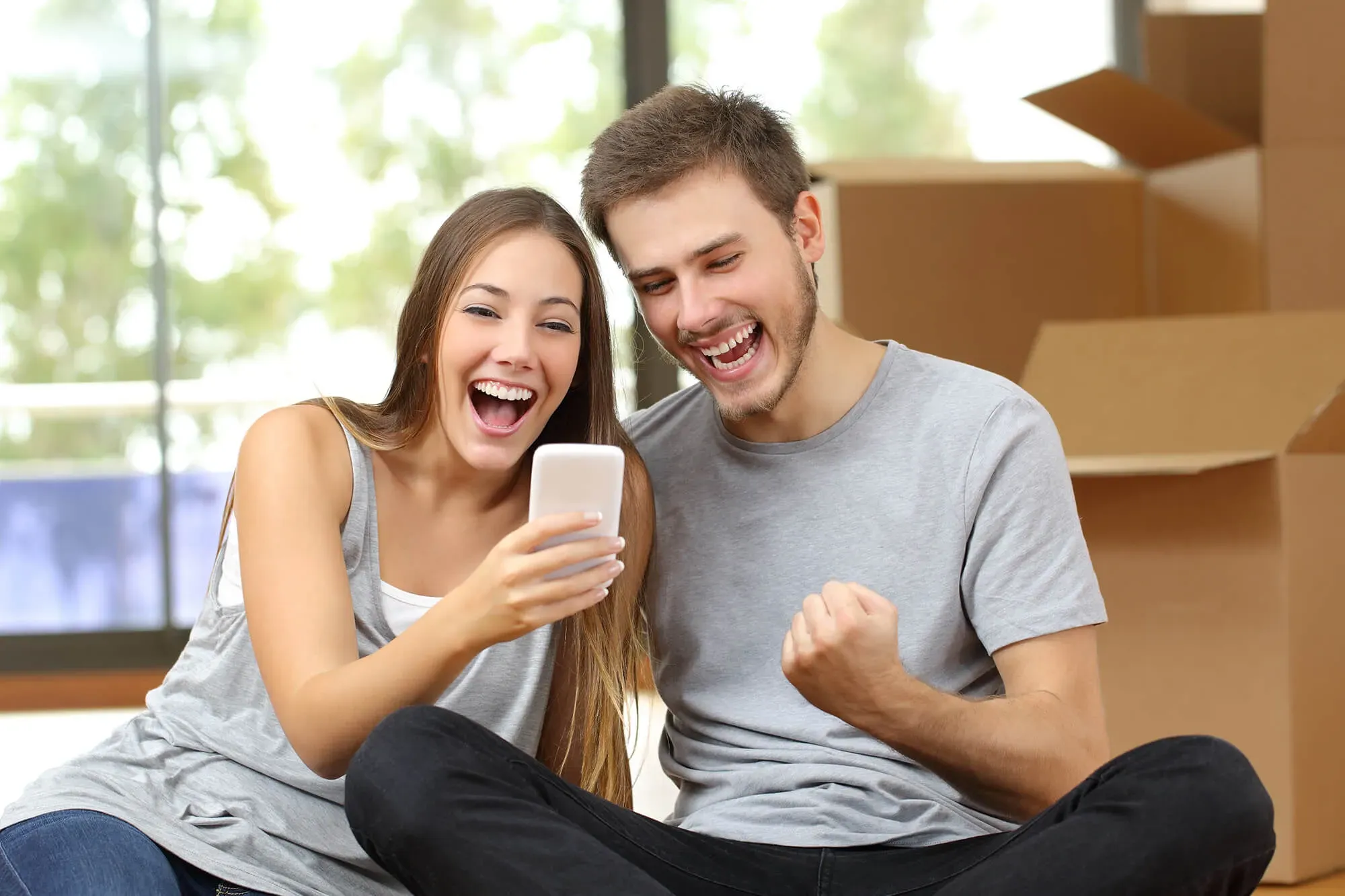 Happy couple looking at a smartphone together