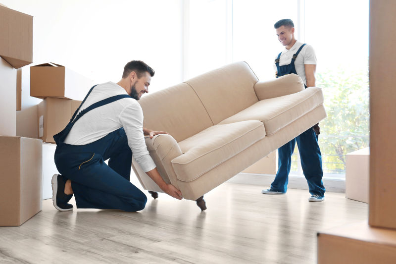 Furniture delivery team setting up a living room