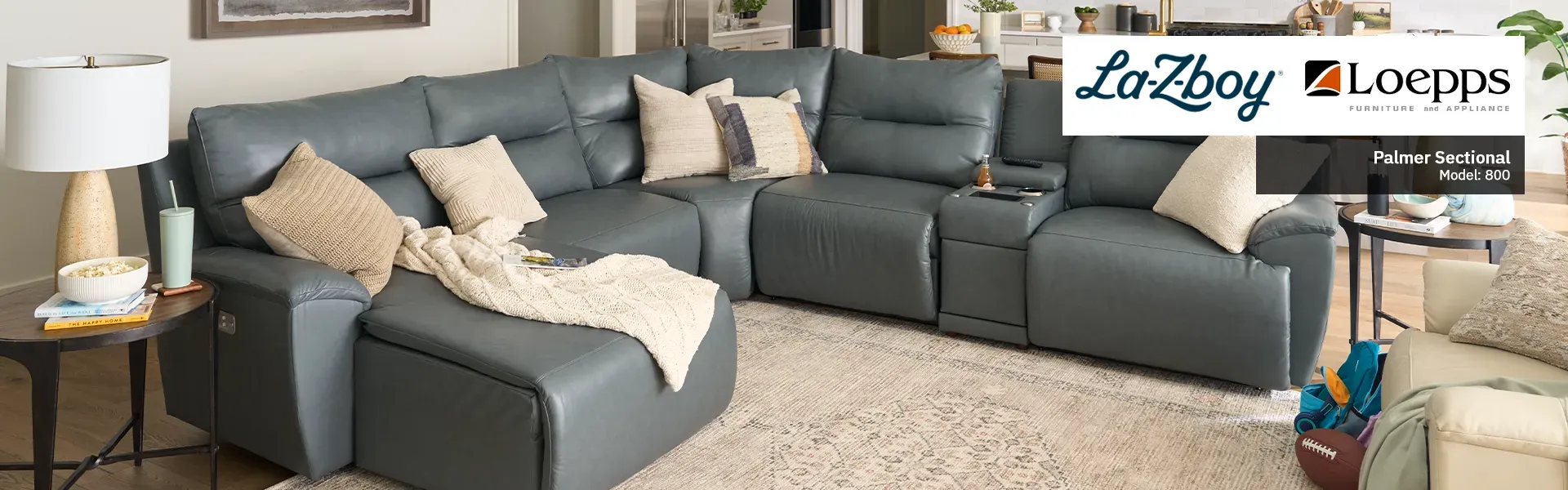 LaZBoy Promo banner with a light gray sectional in a open living room kitchen layout