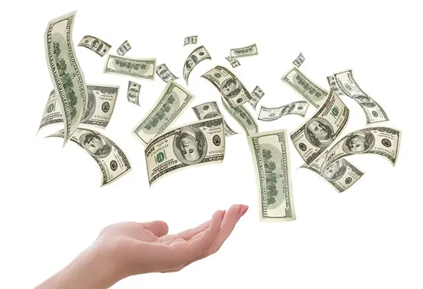 Money falling in to a hand