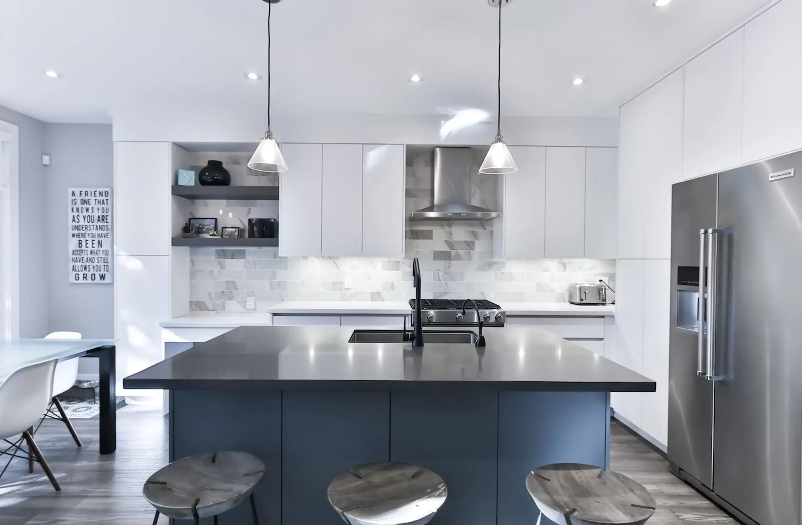 Modern kitchen with quartz waterfall countertop and warm wood cabinetry