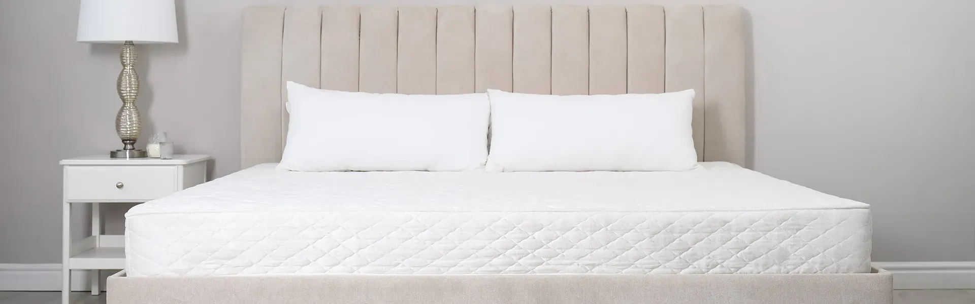 Woman relaxing on a comfortable mattress in a bright bedroom