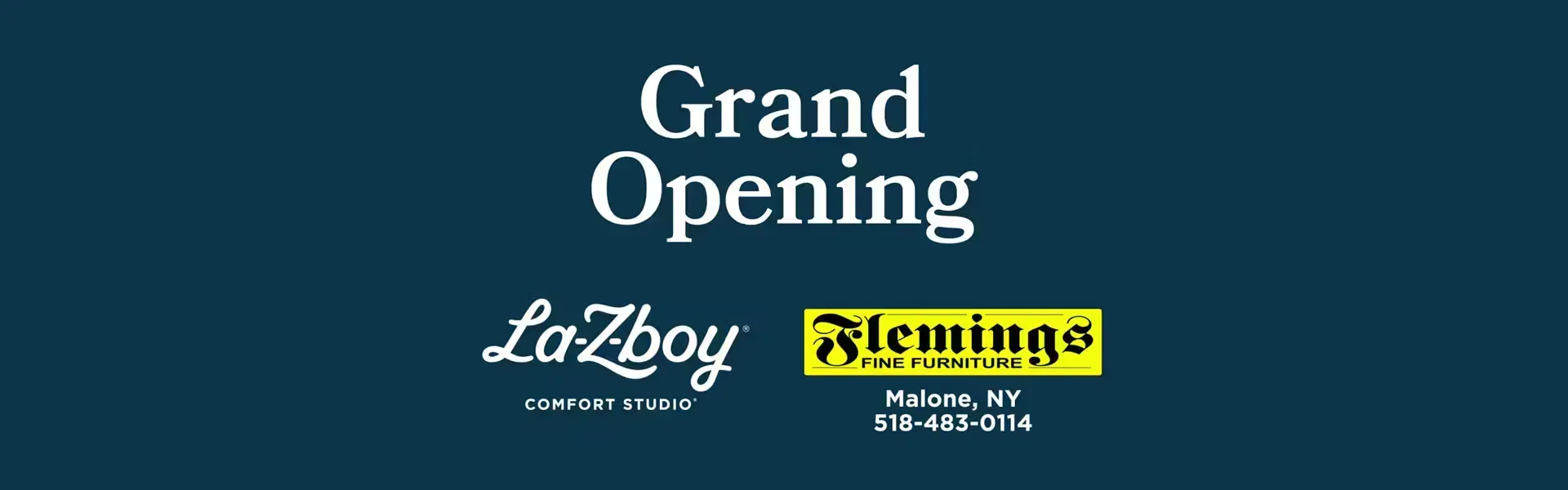 A dark blue promotional banner, displaying the text "Grand Opening | Lazy Boy Comfort Studio" and the "Fleming's Fine Furniture" Logo, with some contact information: Malone, NY 12953 | 518-483-0114