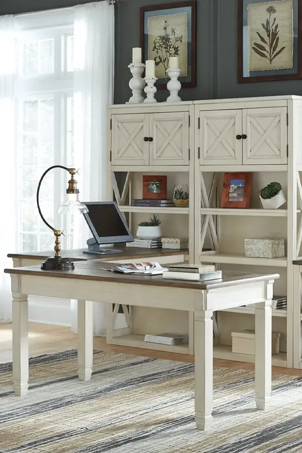 Home office with desk, chair, lamp, and storage cabinet