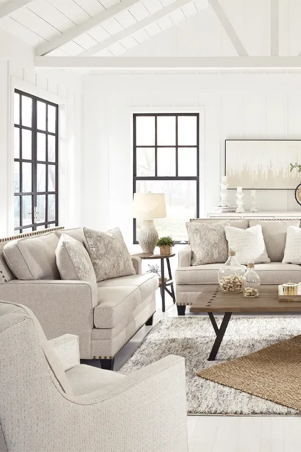 Bright living room with sofa, chairs, and coffee table