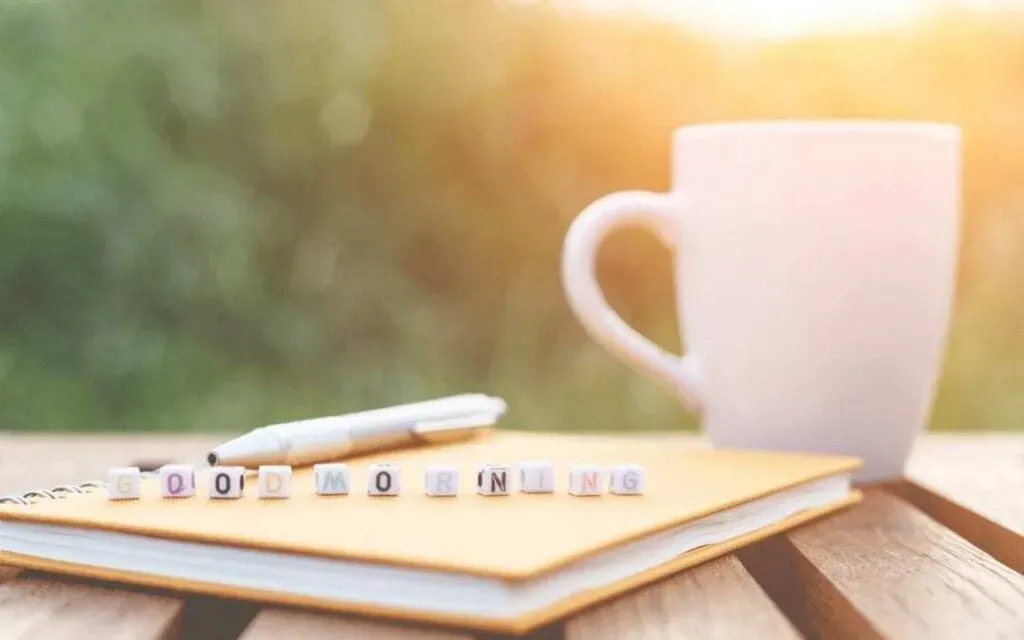Beads-spelling-22good-morning22-on-notebook-beside-mug-in-the-morning-light