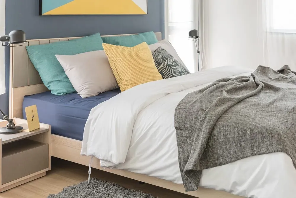 Bright-guest-bedroom-bed-with-colorful-pillows