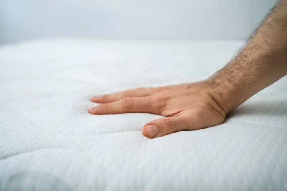 Hand-Touching-a-Plush-Mattress-Topper