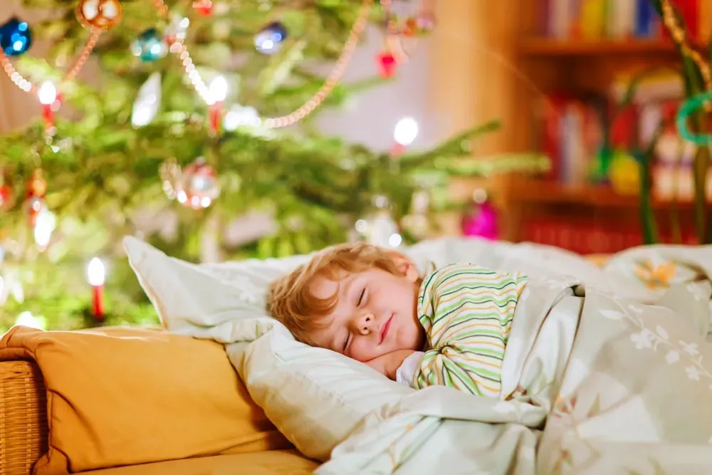 Little-boy-sleeping-peacefully-beneath-christmas-tree