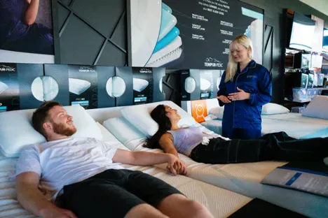 couple laying on mattress