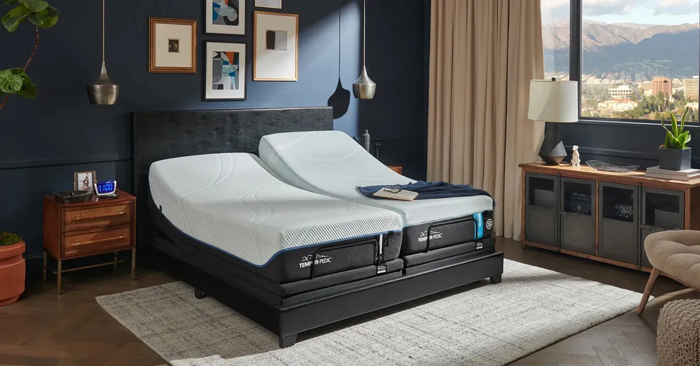 Adjustable Tempur-Pedic mattresses in a modern bedroom with large window view