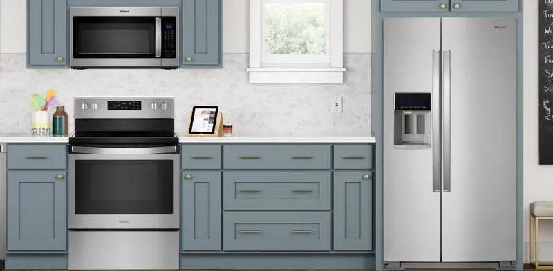 side by side refrigerator blue cabinets