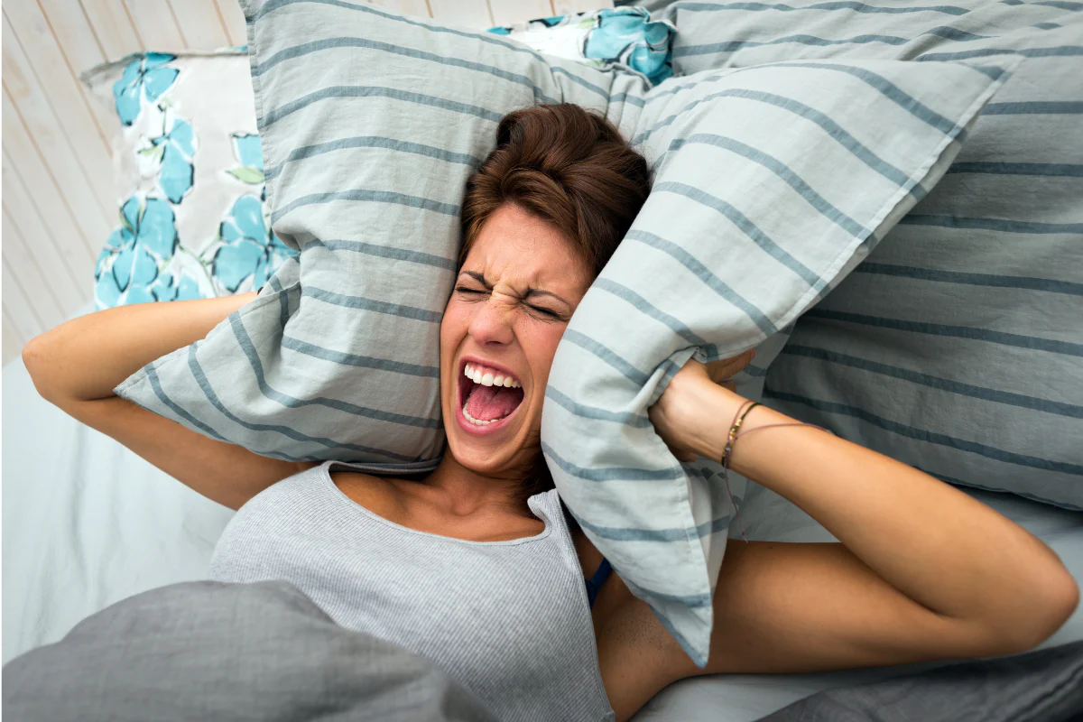 Image of a woman frustrated in her bed