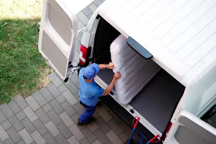 Delivery team loading mattress