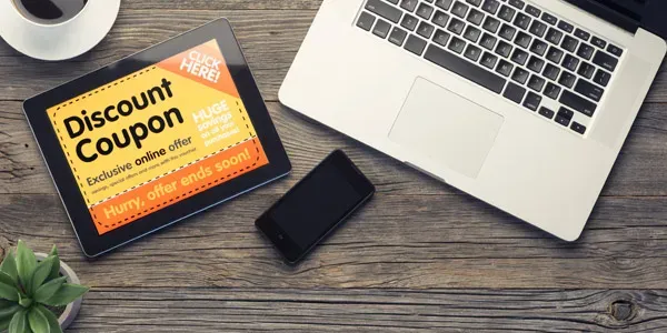 Laptop and tablet showing discount coupon for email savings