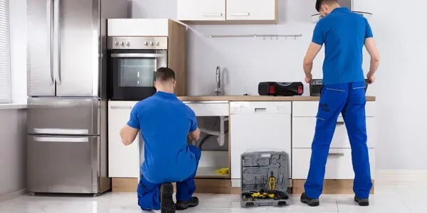 Technicians working in a kitchen for parts and service